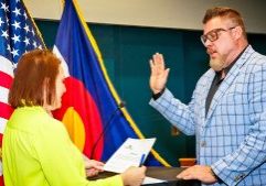 City Clerk Tobi Duffey swearing in District 3 Councilmember Nate Winegar for his first term.