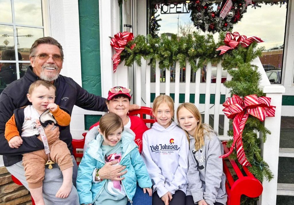 Matt and Kim Gower (Poppa and Gigi) at St. Nick’s Christmas and Collectibles in 2025, with their four beloved grandchildren (from left to right): Tyr, Freyja, Kennedy and KayLee. They take the grandchildren every year to pick out ornaments.