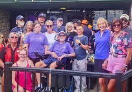 Mark Ryan surrounded by his wife Diane (white tank top), family and friends at the first annual Paul’s Mystery Ship to End ALS’s Summer Bash at Alidade Brewery in Castle Rock. Director Executive Treasurer Paul Cathey (bottom left); Founder and President Bonnie Dannels (bottom right).