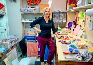 Mary Vielhauer in her garage, surrounded by cement and stained-glass supplies for making stepping stones. Inset photo: The Vielhauer family gathered around the holidays.
