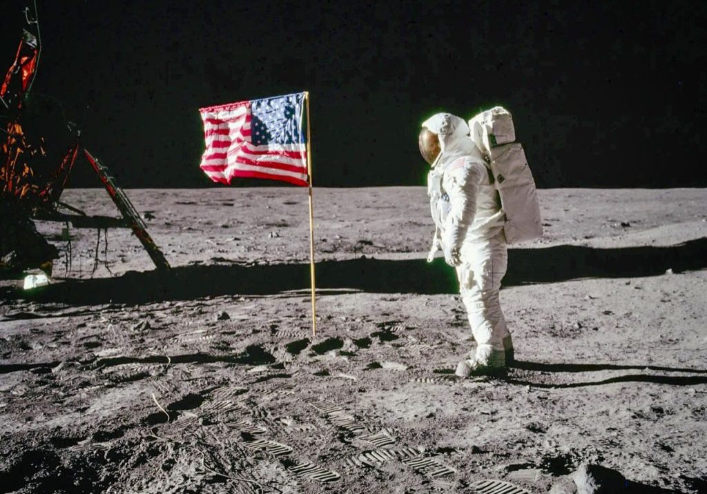 Astronaut Buzz Aldrin stands on the Moon facing a United States flag during the Apollo 11 mission in July 1969. Courtesy of NASA.