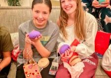 Two soccer teammates excited after opening Rainbow Mystery Dumplings they received from a teammate in a Valentine’s gift exchange.
