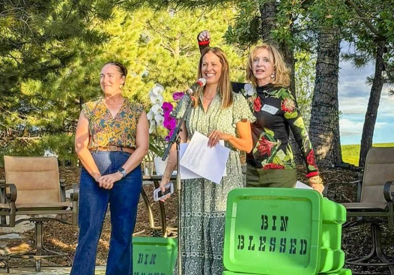 Cy DeBoer, founder of Bin Blessed (far right) gives accolades to President Sheri Flaugherty. Andrea Mosher, There with Care, is far left.