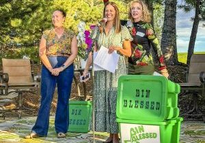 Cy DeBoer, founder of Bin Blessed (far right) gives accolades to President Sheri Flaugherty. Andrea Mosher, There with Care, is far left.