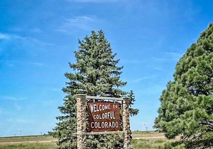 This welcoming sign stands alongside westbound I-70 in the eastern plains where the highway departs Kansas and enters Colorado.