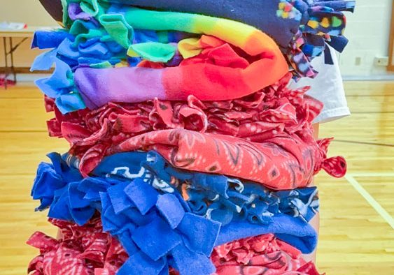 Minnie Musso holds fleece tied blankets bound for Humane Colorado. Minnie organized and ran the service project where she, friends and family made dog blankets and cat scratchers. 