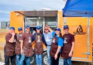 TTR ambassadors, volunteers and Pat Mooney in front of the mobile coffee shop.