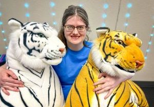 A member of the Wellspring Community program snuggling her two new companions, Snowball and Tony.