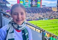 A 13-year-old soccer player watches pregame festivities from the stands before Denver Summit FC’s home opener. 